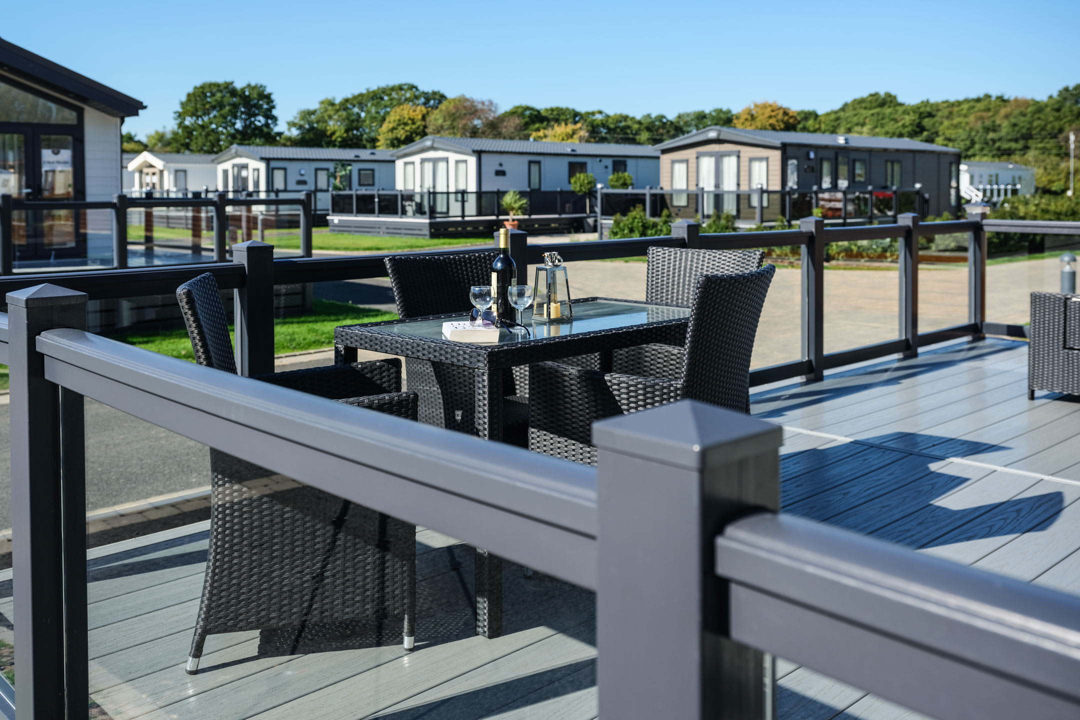 Chiltern decking board in Slate Grey, with Anthracite Grey posts and glass with top rail